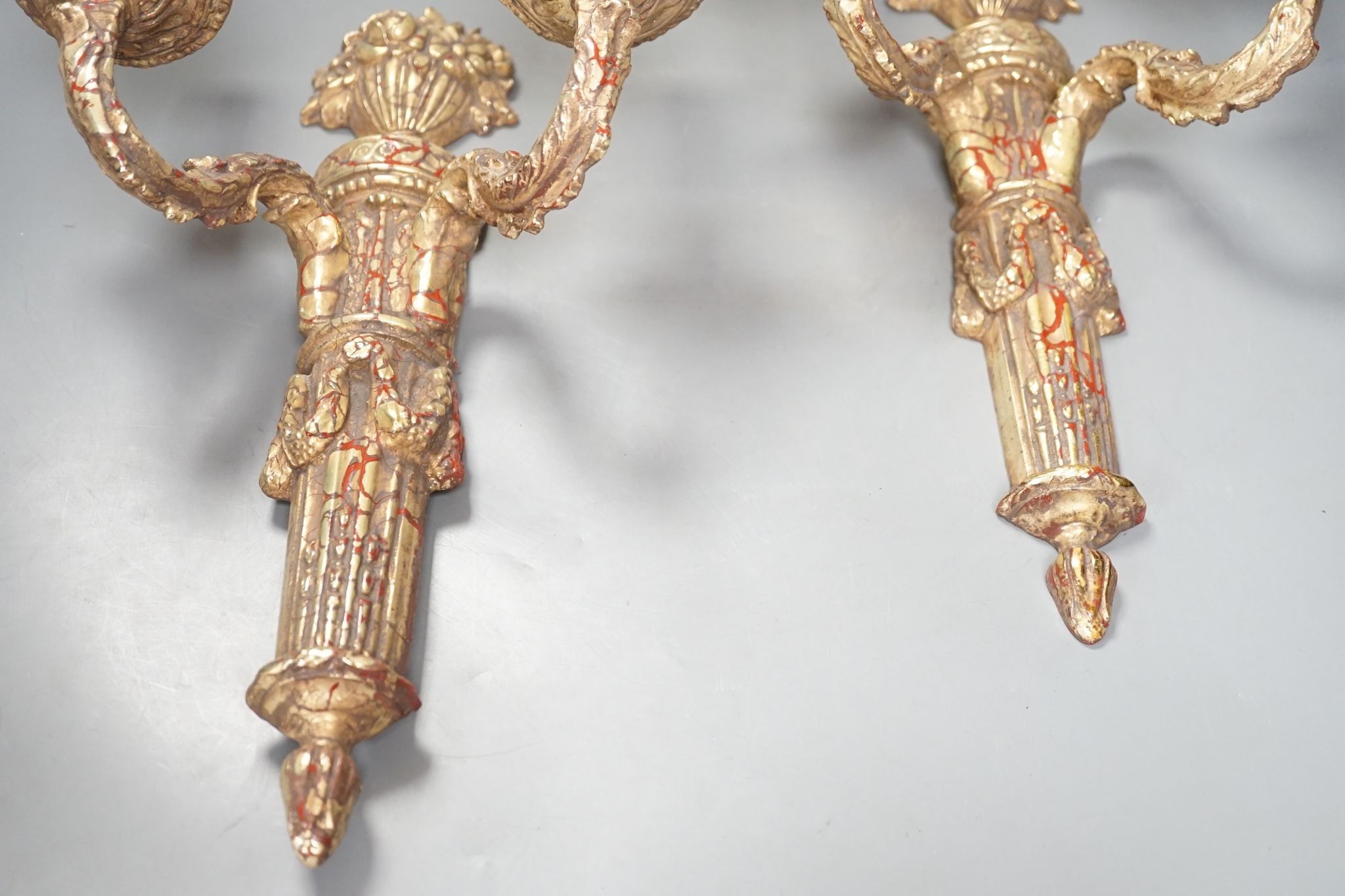 A pair of neo-classical style gilt composition twin-light wall sconces, 38cm